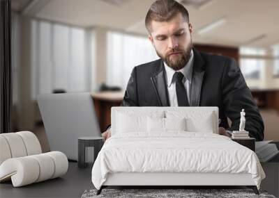 Busy businessman working in office on computer Wall mural