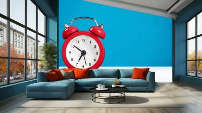 Classic red alarm clock on the desk Wall mural