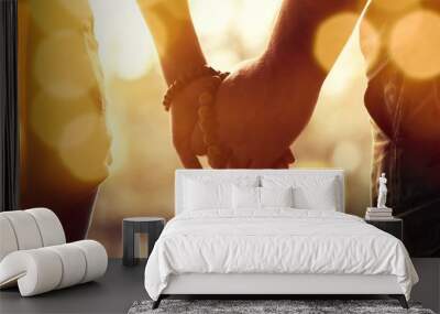 Couple praying together. Holding rosary in hand. Wall mural