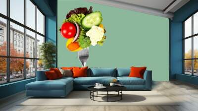 Fresh raw vegetables on fork on blue background Wall mural