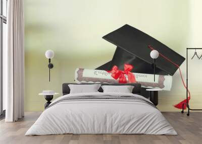 Graduation hat with book and diploma on wooden desk Wall mural