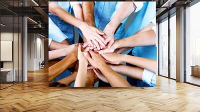 Group of people stacking hands together Wall mural