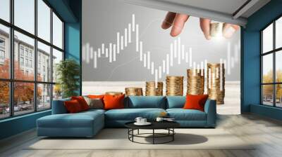 Hand putting coins for growth and investment concept Wall mural