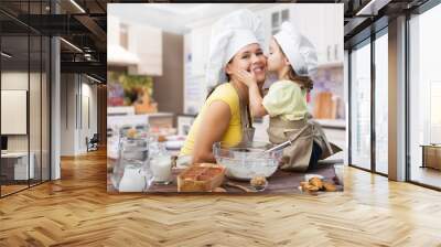 Happy mother and child cooking on kitchen interior Wall mural