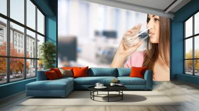 Happy young woman smile drinks a glass water happily in a room Wall mural