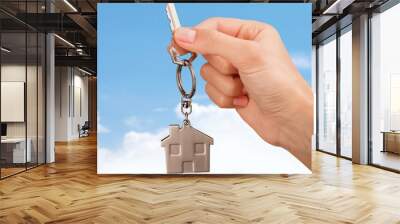 House key in hand on blurred background Wall mural