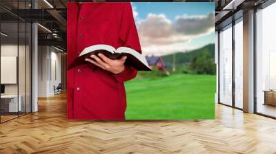 Human hands on the Bible. The process of studying the Bible. Prayer and worship of God. Study of the Holy Scriptures. Studying in theological seminary. Theology. Wall mural