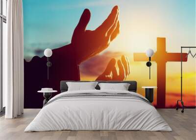 Human male hand on cross background Wall mural