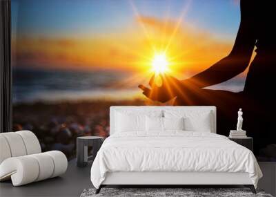 Human silhouette meditating at sunset, yoga relax Wall mural