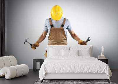 Male builder in hard helmet with drill Wall mural