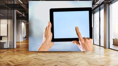 Male hands holding a tablet PC with space for you text isolated Wall mural