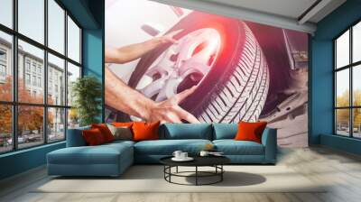 Male hands with Automobile tires on background Wall mural