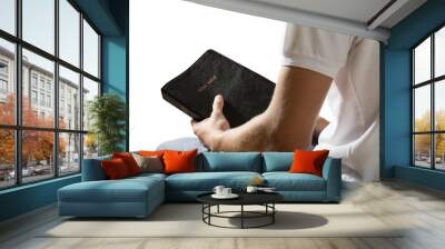 Man holding bible book isolated on white background Wall mural