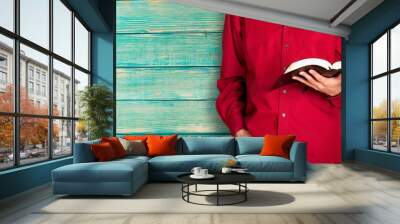 Man reading old heavy book on background Wall mural