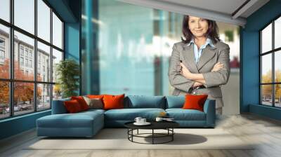 Mature businesswoman wearing formal suit on background Wall mural