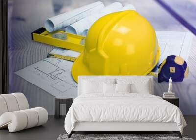 Paper blueprints, a yellow hardhat, and tools Wall mural