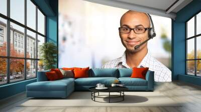 Portrait of a smiling man with headset working as a call center operator Wall mural