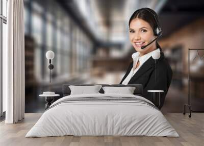 Portrait of female worker in headset presenting report Wall mural