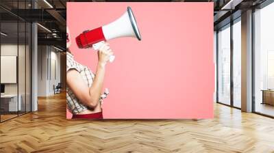 Portrait of woman holding megaphone, dressed in pin-up style Wall mural