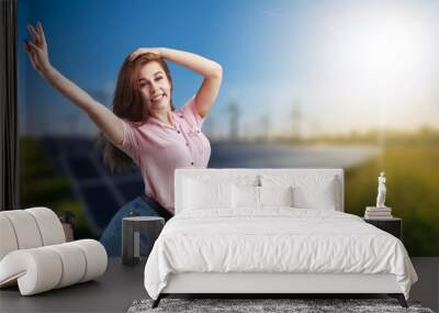 Portrait of young happy excited woman with solar panels. Wall mural