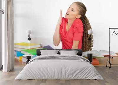 Pretty young woman with heap of books isolated on white Wall mural