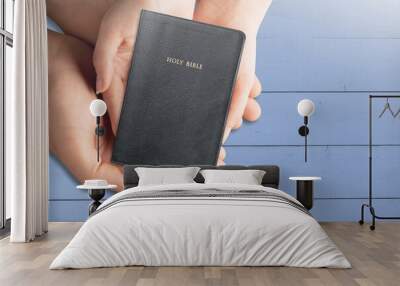 Reading bible study. Hands holding on a Holy Bible. faith, spirituality and religion Wall mural