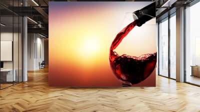 Red wine pouring from the bottle in glass Wall mural