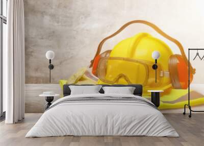 Safety helmet with earphones and goggles on construction background Wall mural