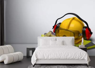 Safety helmet with earphones and goggles on construction Wall mural