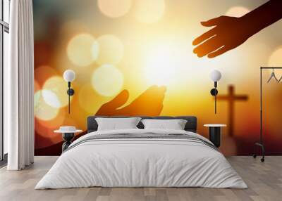 Silhouette hand  on Christmas sunset background, Jesus reaching concept Wall mural