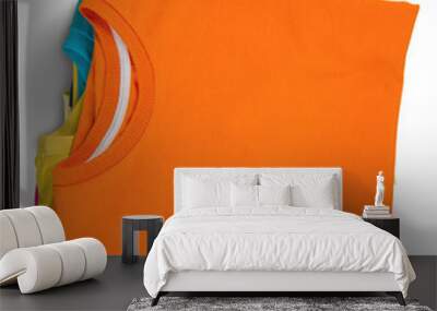 Stack of colorful t-shirts on white background Wall mural