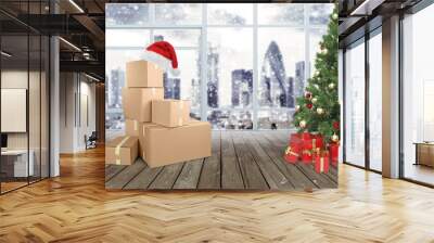 Stack or heap of brown carton cardboard boxes with red Santa hat, Christmas shopping or online ordering concept Wall mural