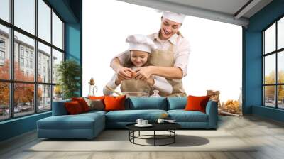 The beautiful young mother and her little daughter cook at home Wall mural