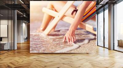 Woman at beautiful beach relaxing on the chair Wall mural