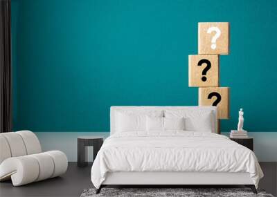 Wooden cube block with question mark mean what on table background Wall mural