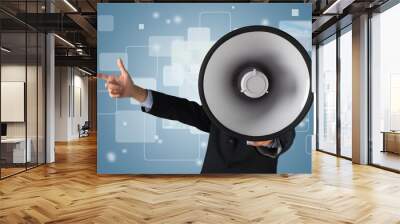 Young businessman talking on the megaphone on background Wall mural