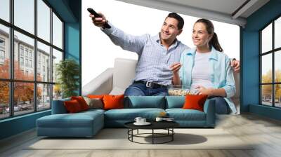 Young couple watching tv siting on a sofa Wall mural