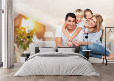 Young family at home smiling at camera Wall mural