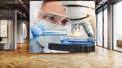 Young Female Scientist Working with Microscope Wall mural