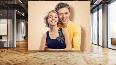 Young smiling couple friends posing Wall mural