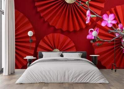 Lucky Chinese new year red background decoration with cherry blossom flower and paper fan Wall mural