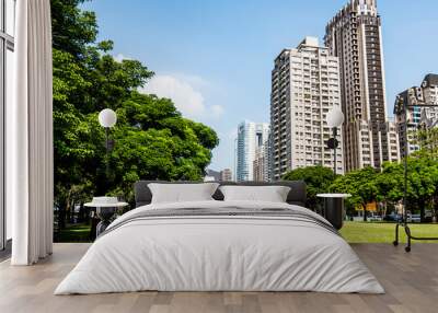 Low-angle view of green park space and modern buildings on both sides in downtown Taichung, Taiwan. here is near the National Taichung Theater. Wall mural