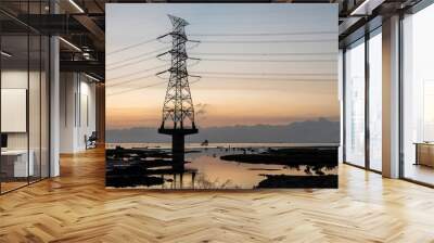 Silhouette of high voltage tower and electric line with the sunset background on the west coast of Taiwan. Wall mural