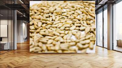 Peeled sunflower seeds. Sunflower seeds on white background. Wall mural