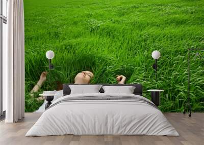 beautiful girl lying down of grass Wall mural