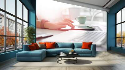 Hand touching a tablet screen to work Concept of using technology Wall mural