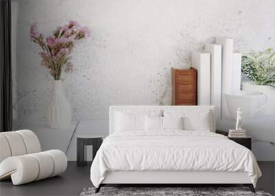 Vase of flowers and books arranged in a row. Wall mural