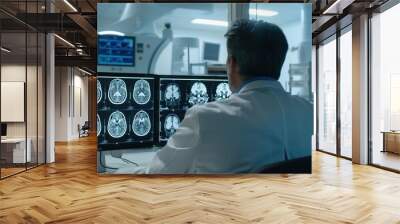 Radiologist at dual monitor workstation reading CT head Wall mural