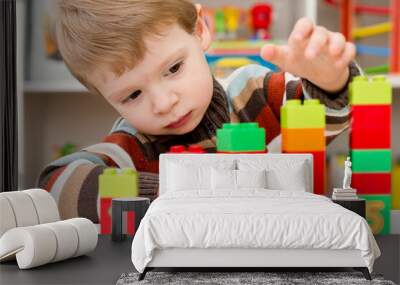 Learning to count. 2 year old boy stacking Duplo blocks. children, infancy and education concept. formation and development of the child. Montessori and early development Wall mural