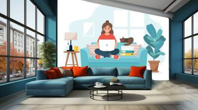 Home office concept, woman working from home sitting on a sofa, student or freelancer. Wall mural